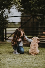 shallow focus photography of child petting puppy