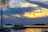 Sunset view from the deck of a luxury expedition yacht cruising near a secluded island.