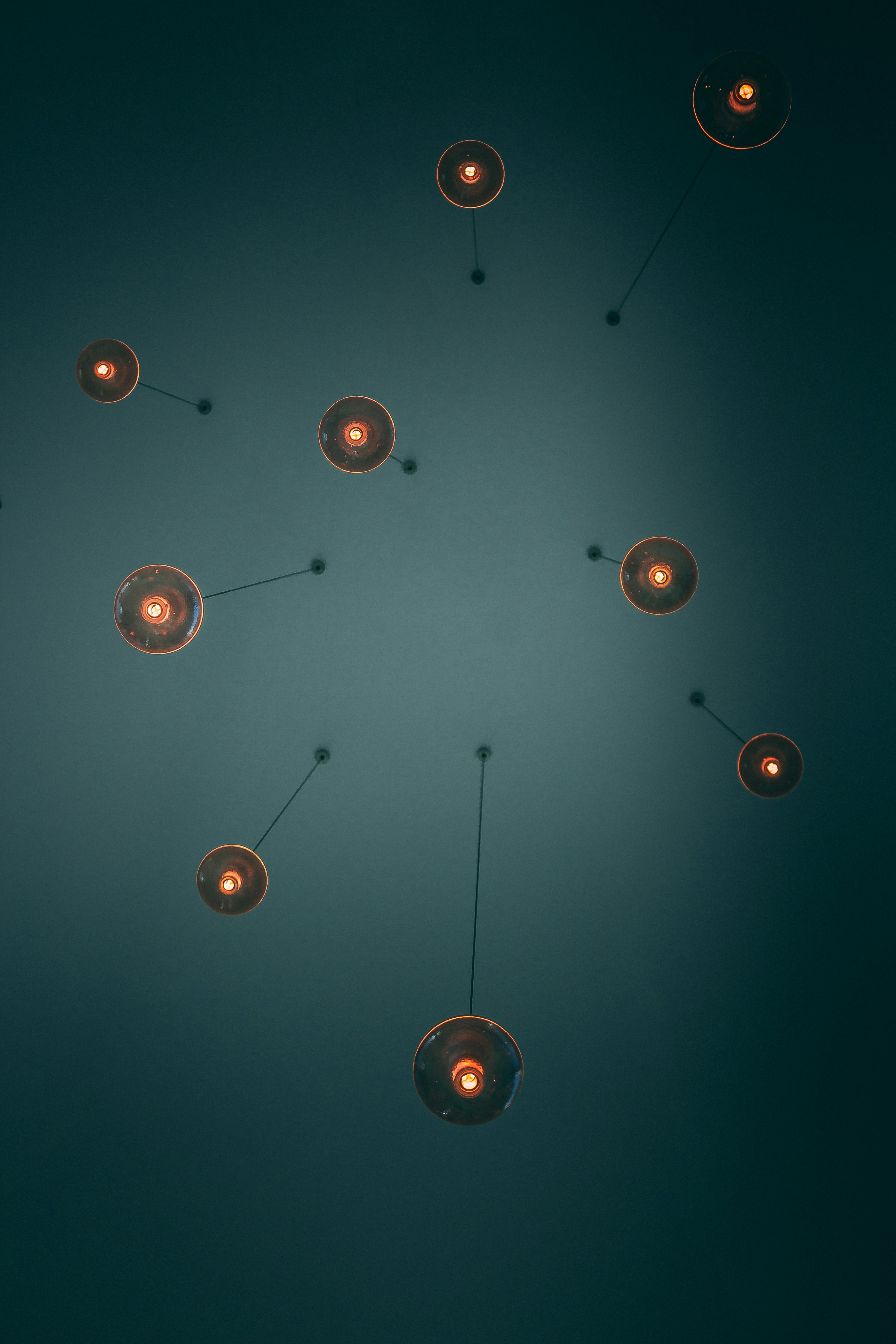 low-angle photo of turned on brown pendant lamps