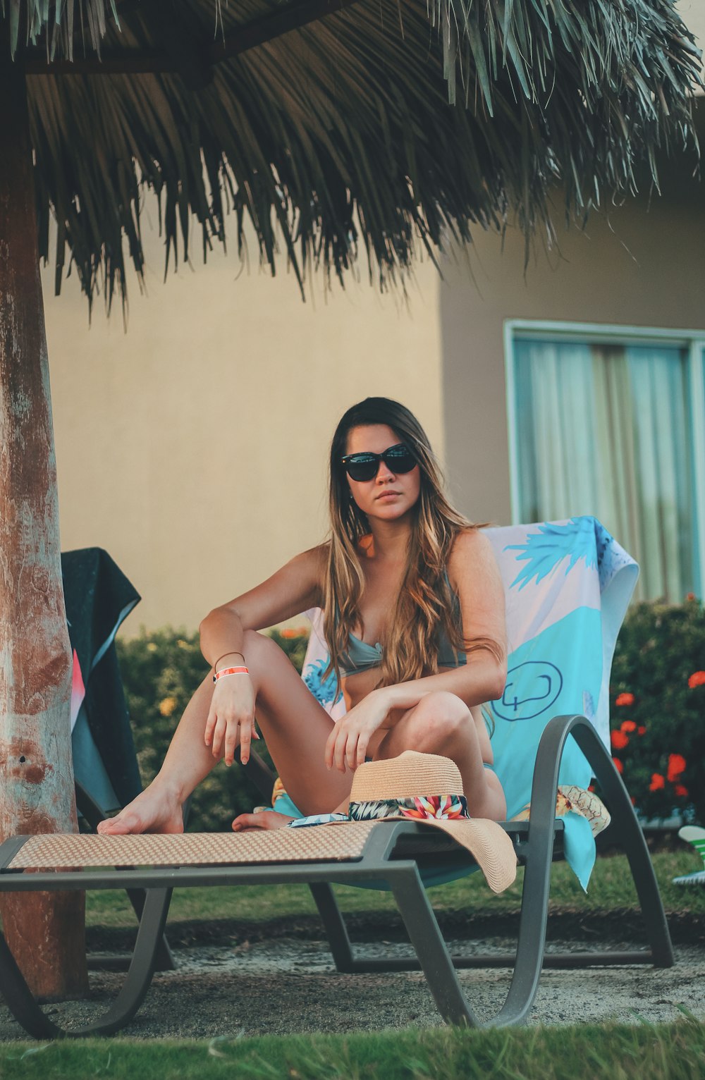 woman siting on gray lounge chair