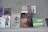 A collection of various books is arranged on a flat surface against a gray background. The books include titles on art, history, and biographies, featuring covers with illustrations of historical figures, artwork, and text in different languages.