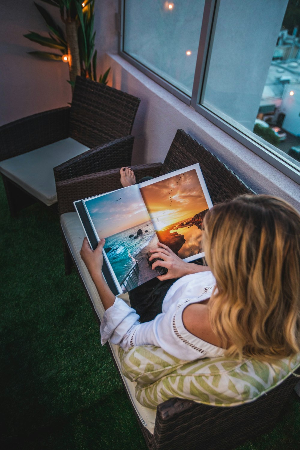 woman sitting on 2-seat sofa