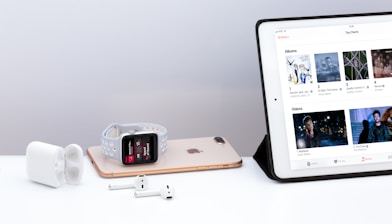 silver iPad near white Apple AirPods