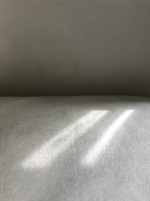 Natural light casting gentle patterns on smooth crystal surfaces and soft shadows.