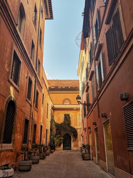 low angle photo of brown concrete buildings in Piazza di Spagna Italy