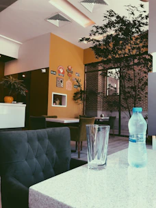 A cozy café setting with Airtis water bottles on the table, showing partnership with Horeka.