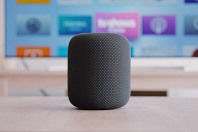 black Apple HomePod speaker on table