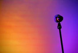 Dynamic visualization of AI voice waves emanating from a microphone icon in a dark blue gradient.