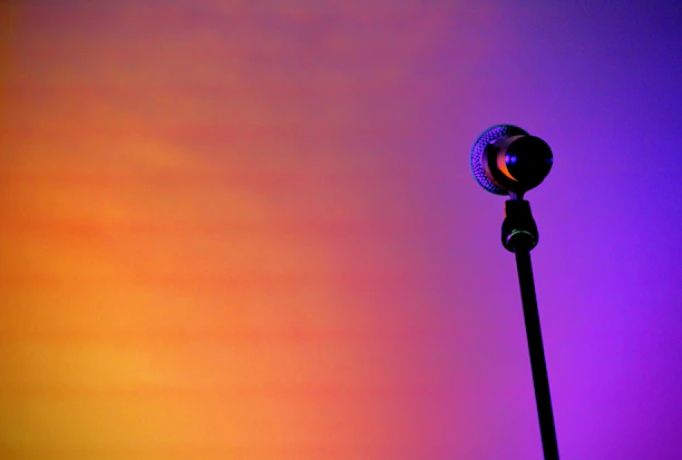 A vibrant comic-style illustration of a microphone with tropical waves and bold cyan, yellow, and coral colors.