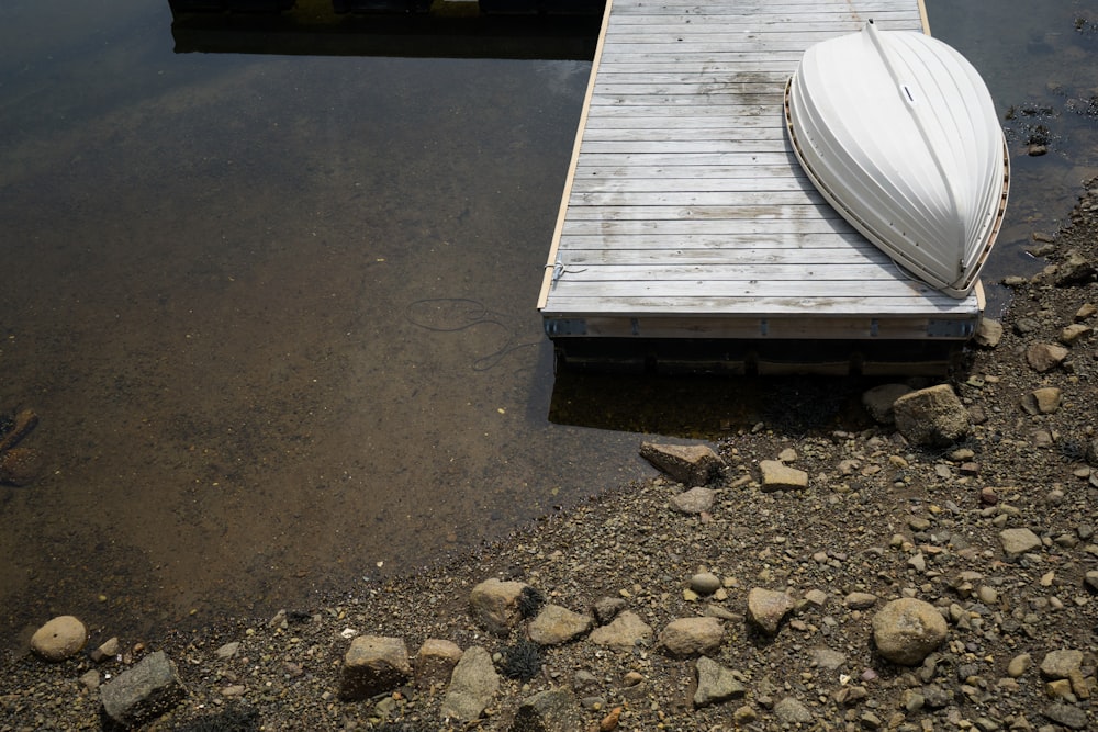 white boat on gray dock