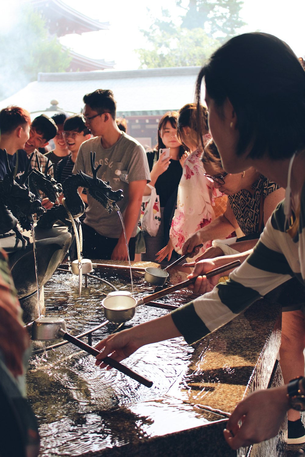 group of people about to filling water in pots