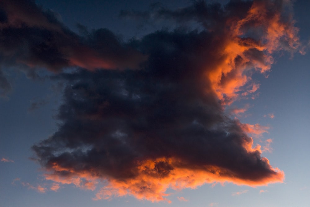 black and orange clouds under blue sky