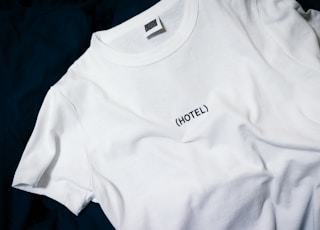 white hotel-printed crew-neck shirt on black surface