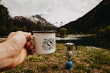 person holding white cup outdoors