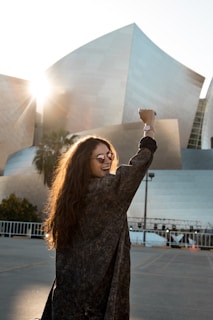 woman walking towards grey building for los angeles video production