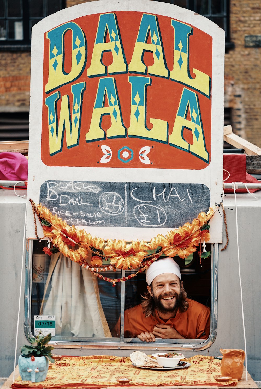 man inside Daal Wala store signage