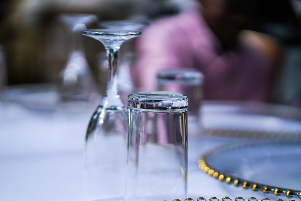 clear flute and highball glasses upside down on table