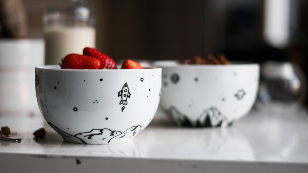 two white-and-black ceramic bowls on wooden table