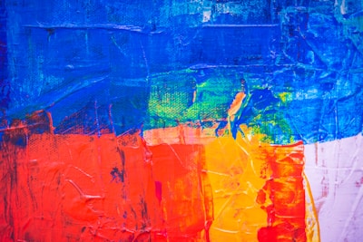 A vibrant, textured canvas featuring bold brushstrokes and rich colors.