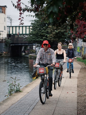 three people riding bicycle
