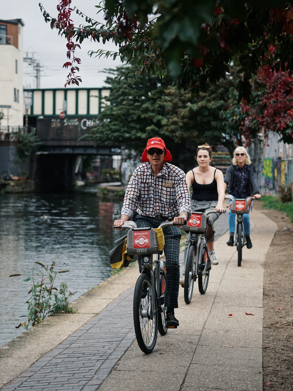 three people riding bicycle