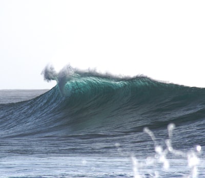 long exposure photography of body of water wave teams background