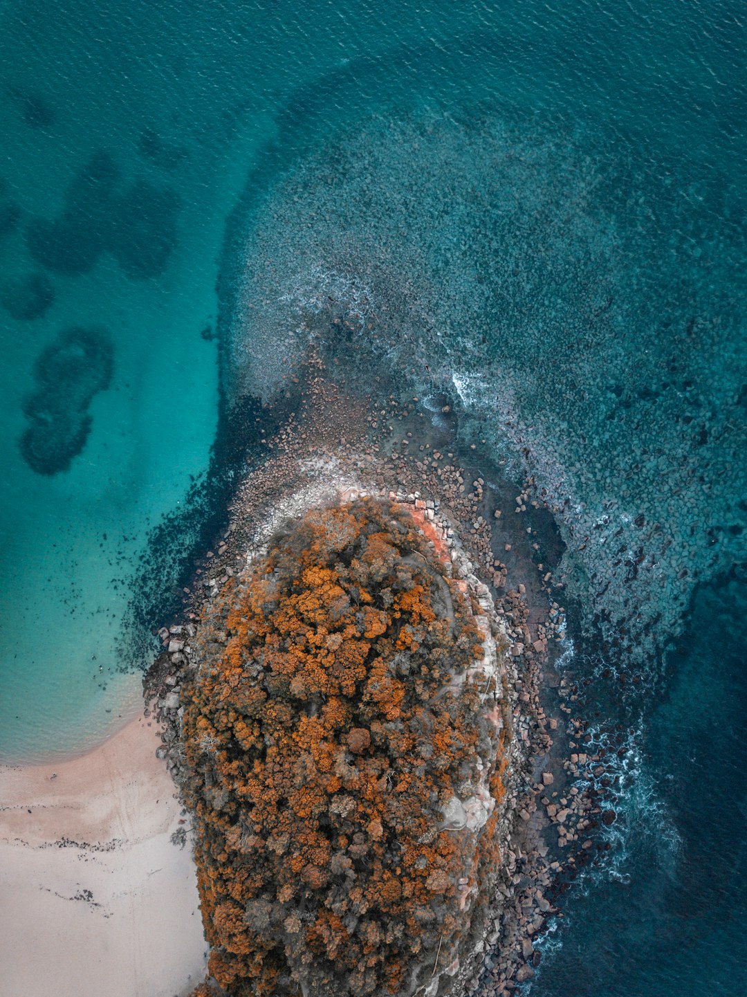 bird's-eye view photo rocks near seashore