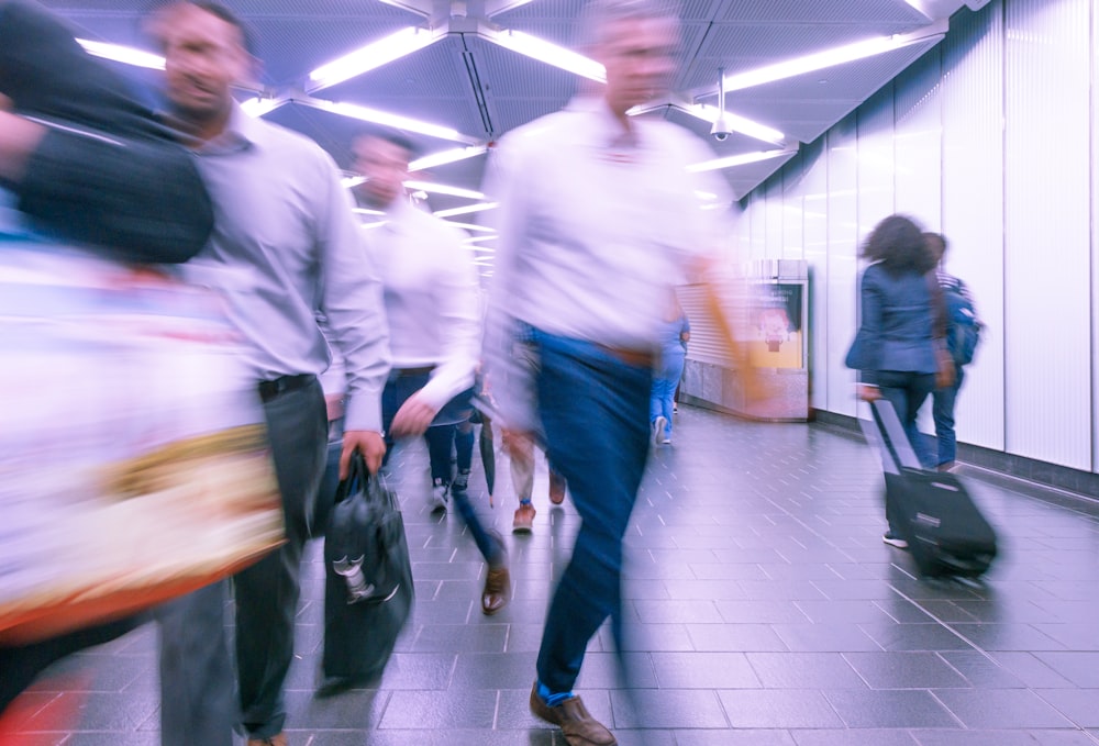 people walking inside white hall