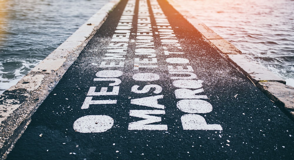 gray asphalt road with text