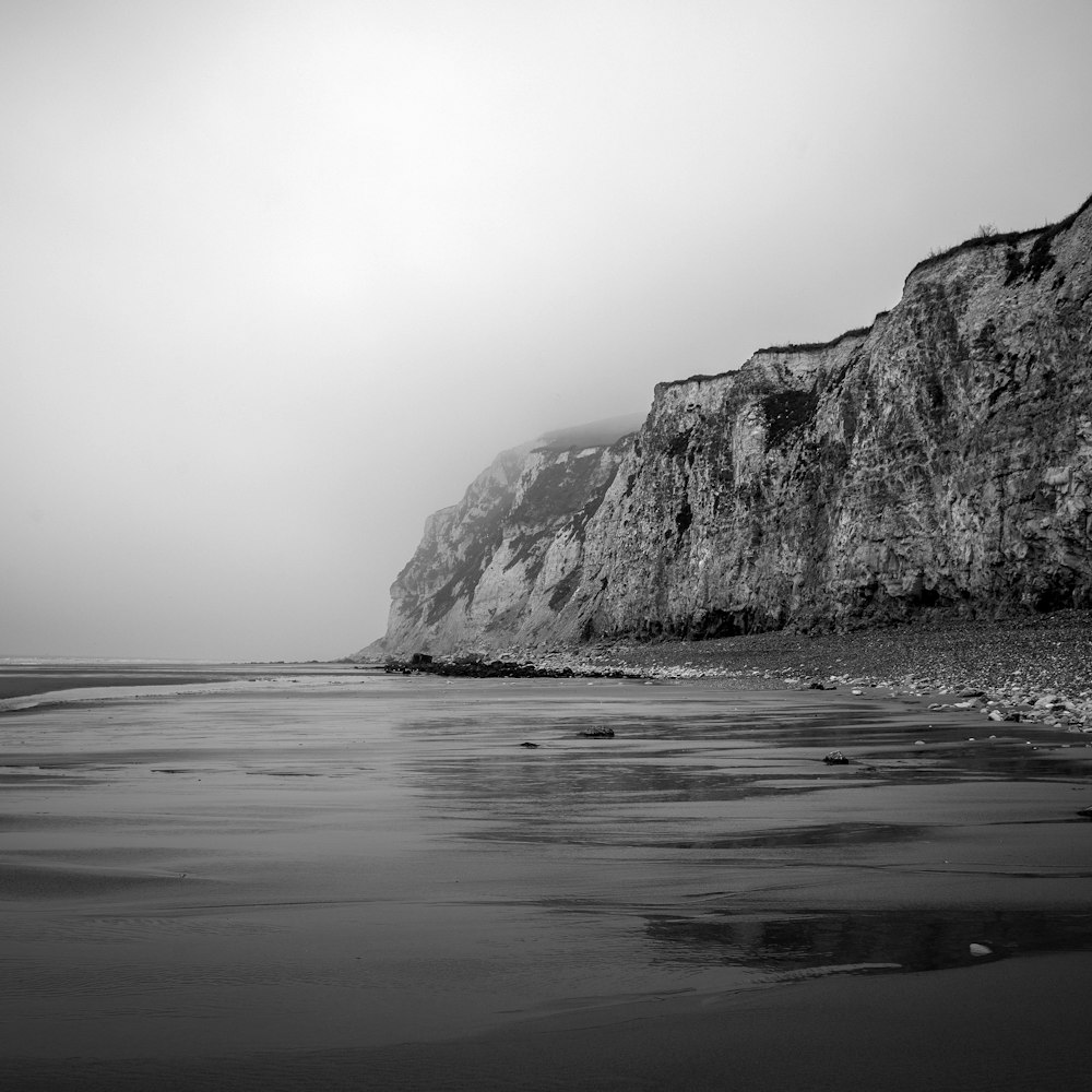 cliff beside body of water