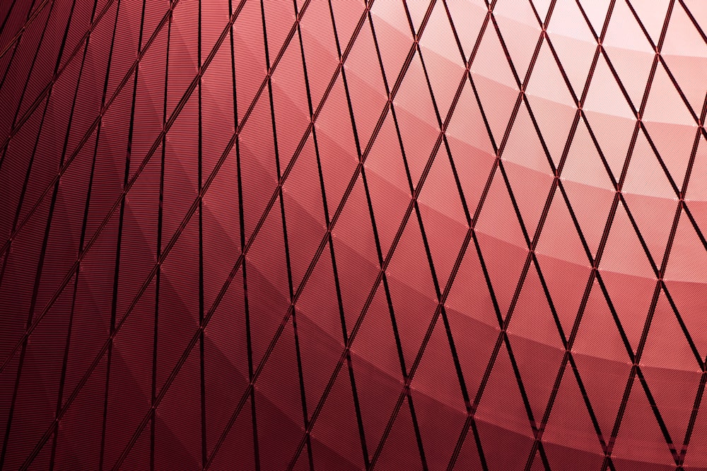 a close up of a net with a red background