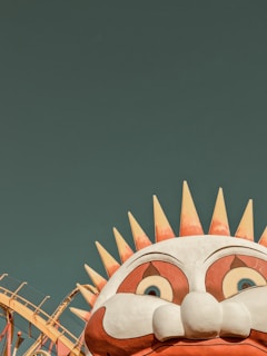 Close-up of a large, colorful theme park decoration featuring whimsical characters and vibrant colors.