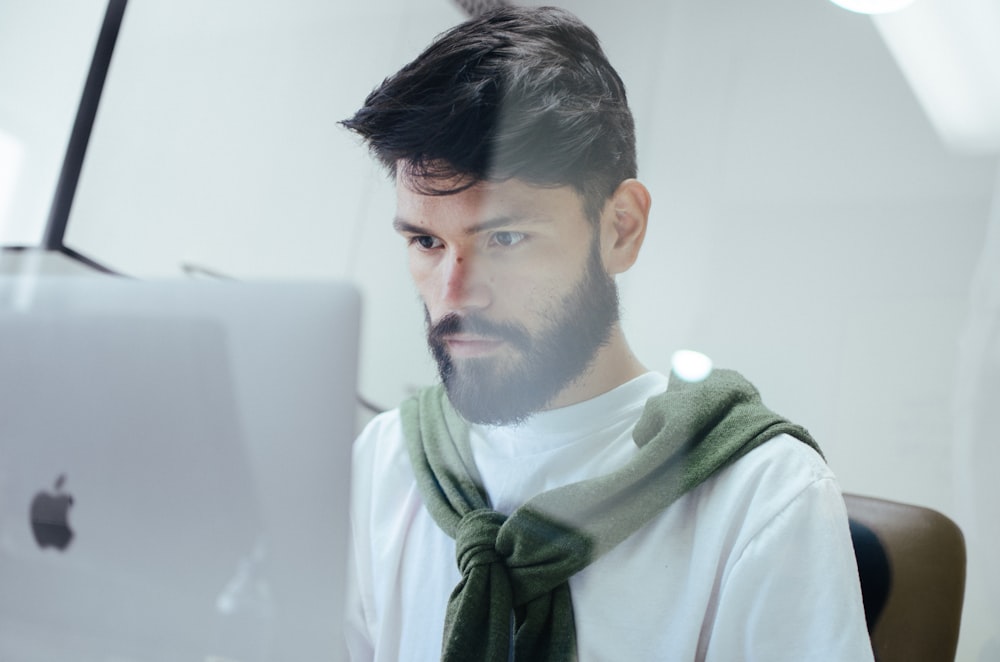 man facing MacBook Pro