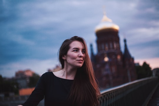 woman taking photo near building in Saint Petersburg Russia