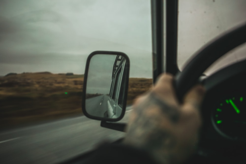 person holding steering wheel