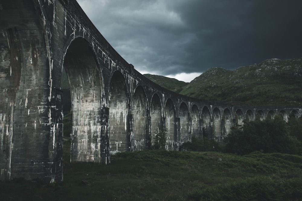 grey concrete bridge near hills