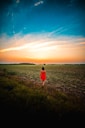 woman walking in a grass field
