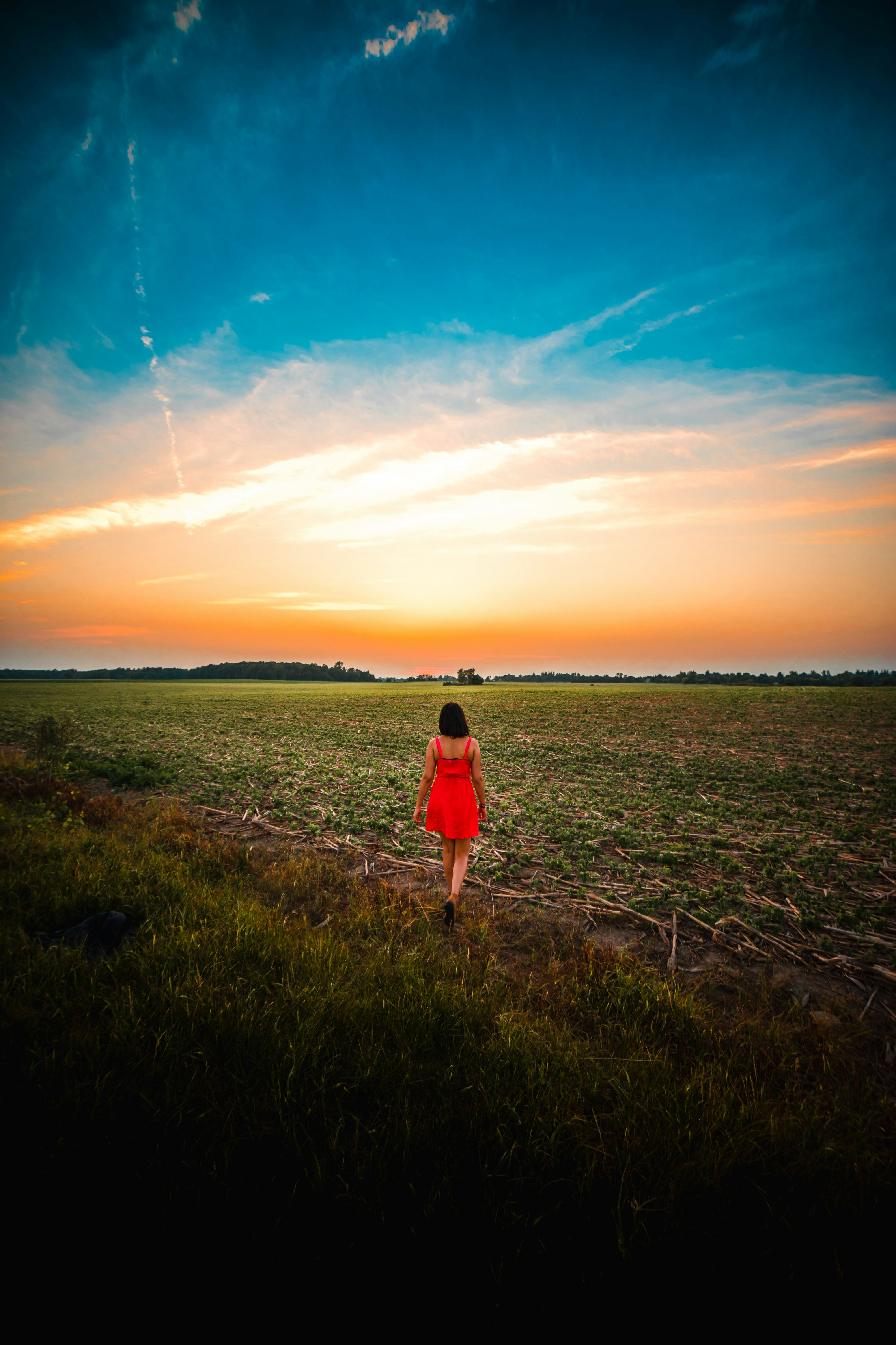 woman walking in a grass field