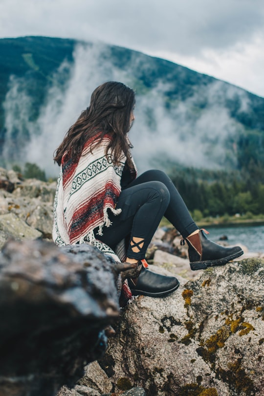 woman sitting on rock formation in Jones Lake Canada