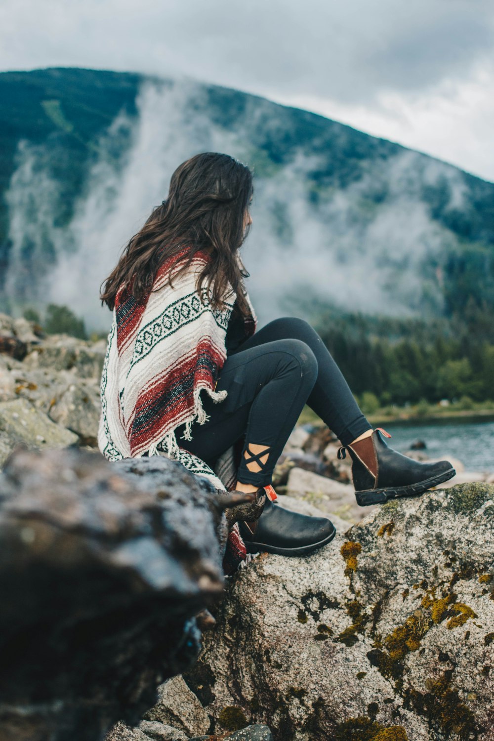 woman sitting on rock formation