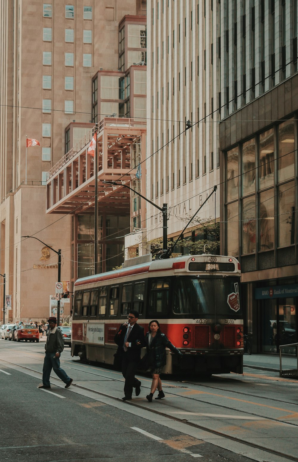 man and woman walking near city tram