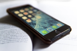 Close-up of a smartphone screen showing the smart book-finding app with a glowing indicator on the shelf.