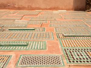 Traditional Moroccan riad courtyard with warm earth tones and intricate tile work.