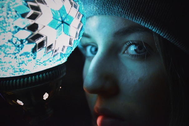 Close-up of the tazik mascot wearing funny goggles and a colorful hat, glowing softly with neon outlines.