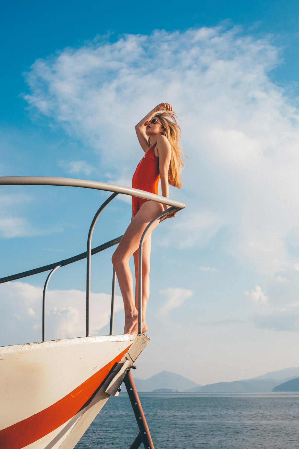 woman standing on white yacht