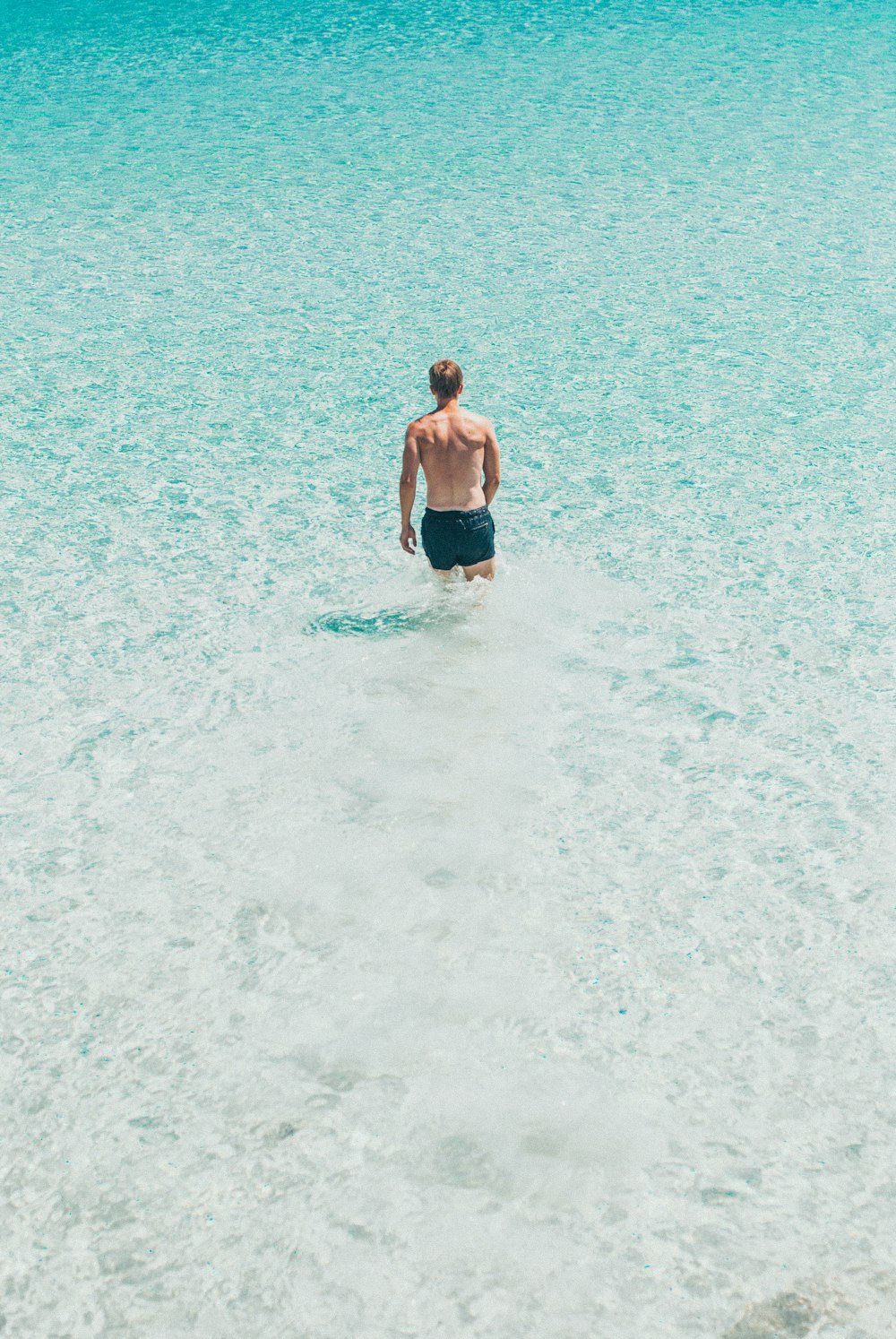 person walking on shallow water