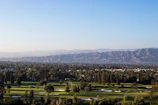A golf course view from the villa with lush green fairways under a clear sky