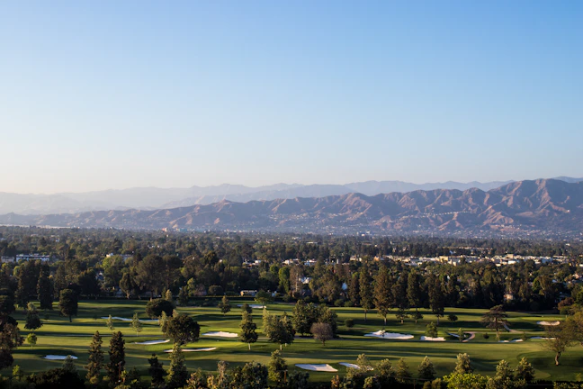 A golf course view from the villa with lush green fairways under a clear sky