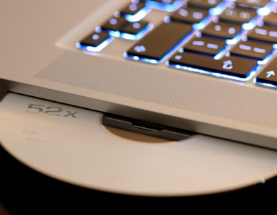 white disc on laptop computer disc player