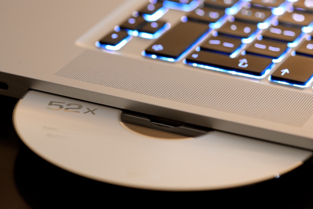 white disc on laptop computer disc player